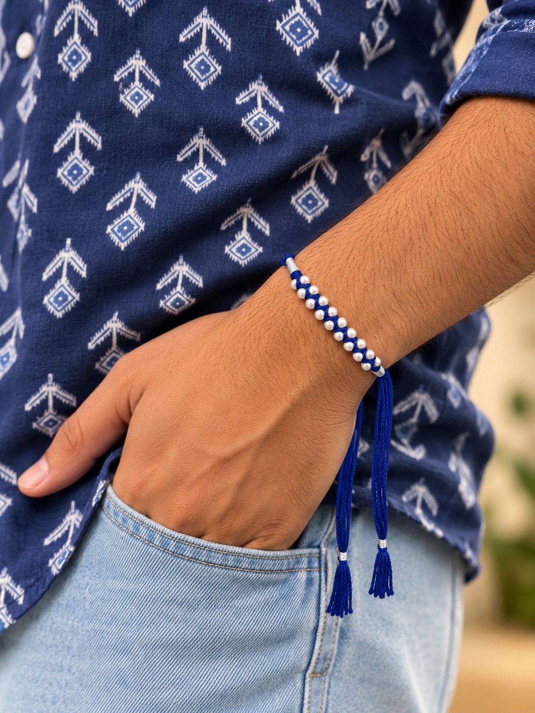 Neel Moti Rakhi, blue thread woven with pearls, worn on wrist