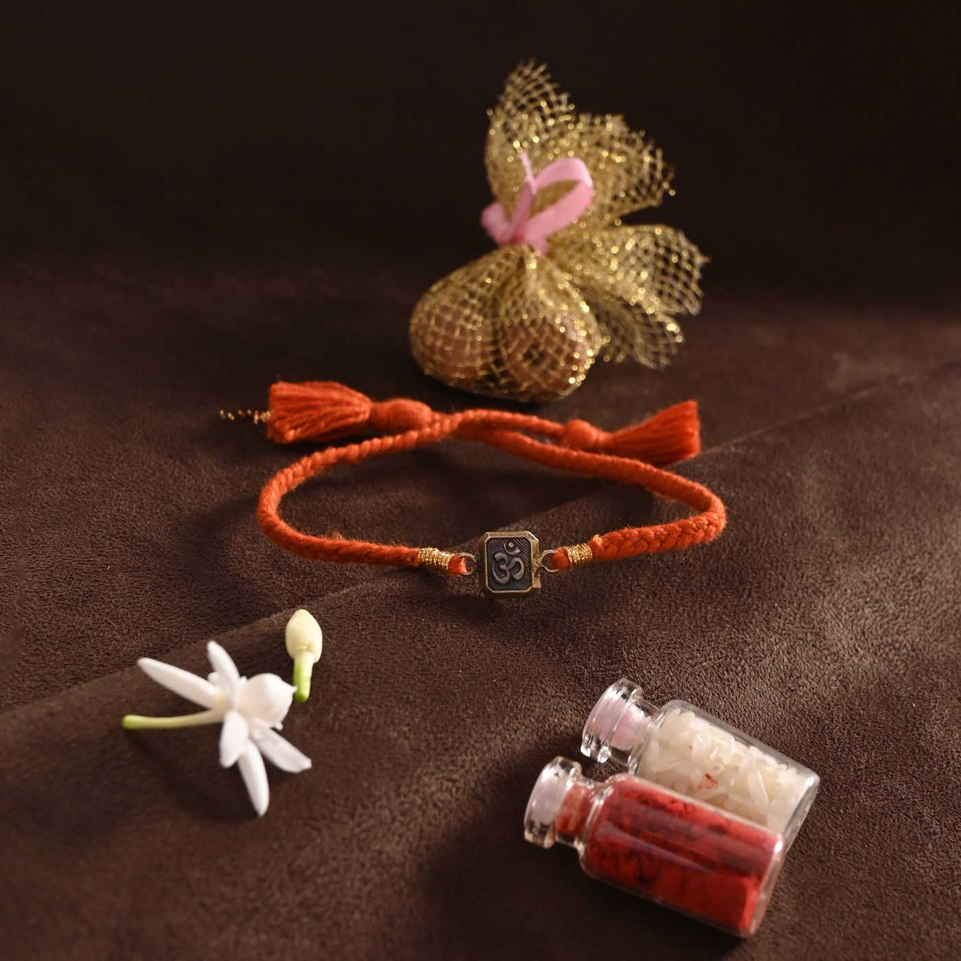 Om Rakhi, rust thread with Om engraved charm