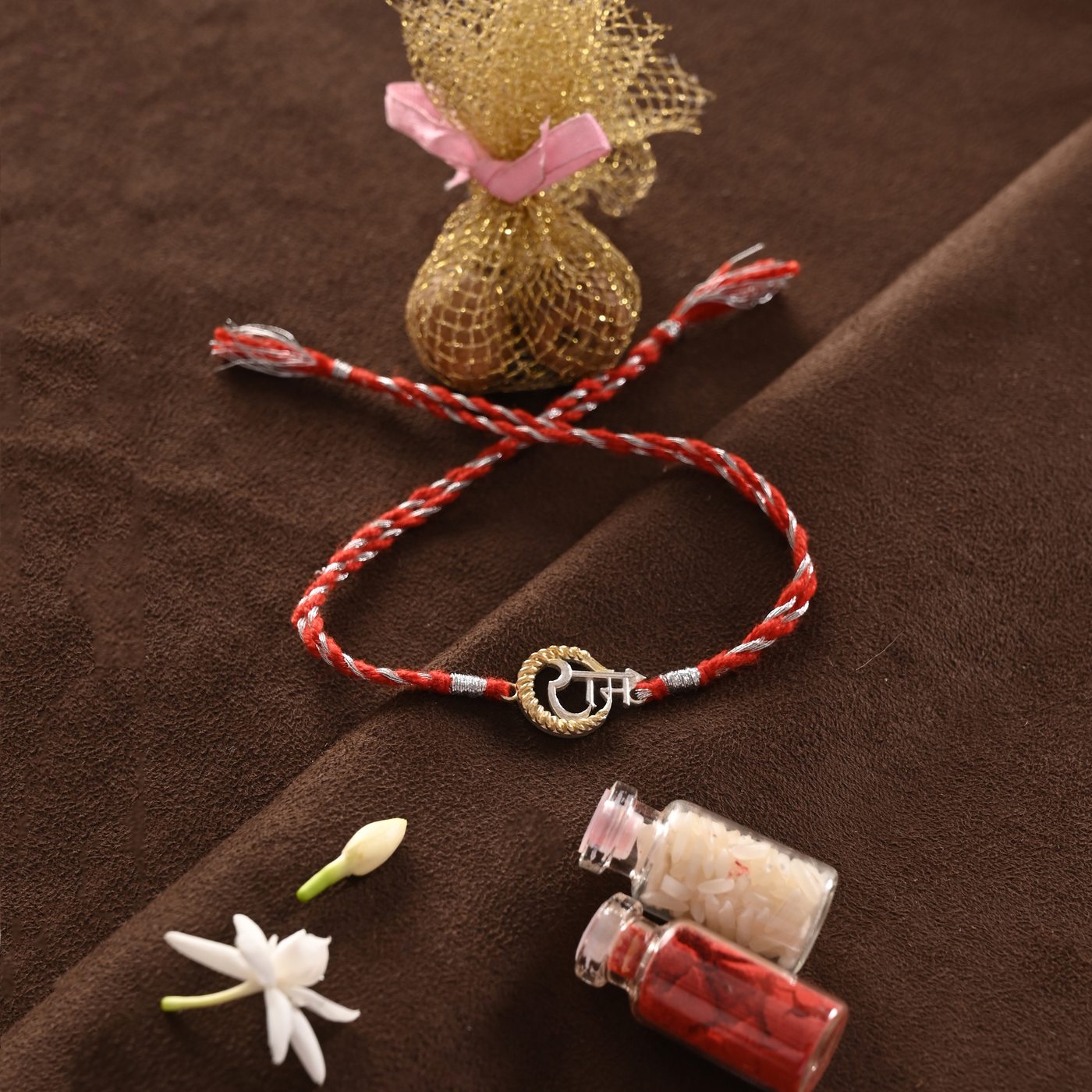Ram Rakhi, red and silver thread with Ram charm